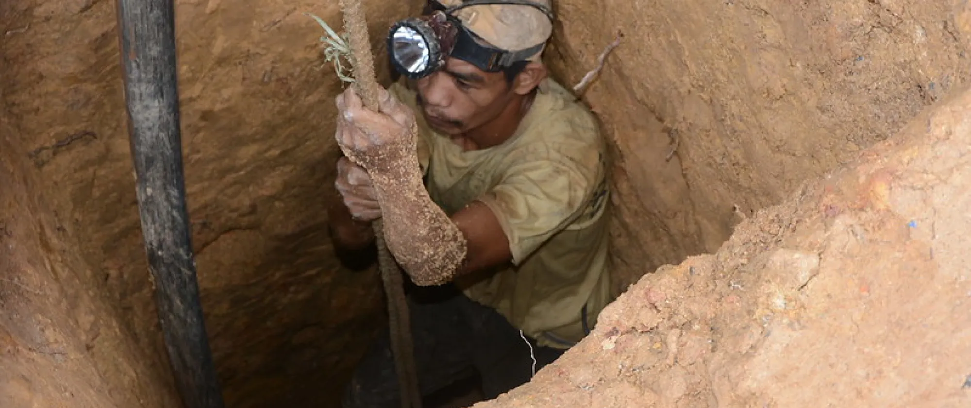 man going down a mine hole