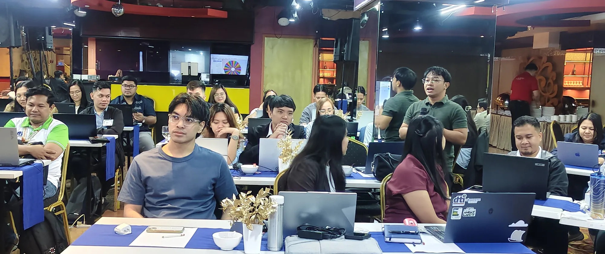 Trade officials participate in a training using their computers and AI