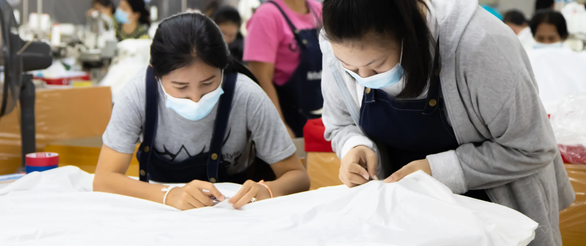 Two female workers sewing garments. 