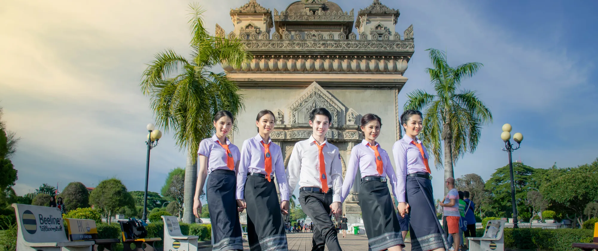 Group of student pose in front of a city gate.