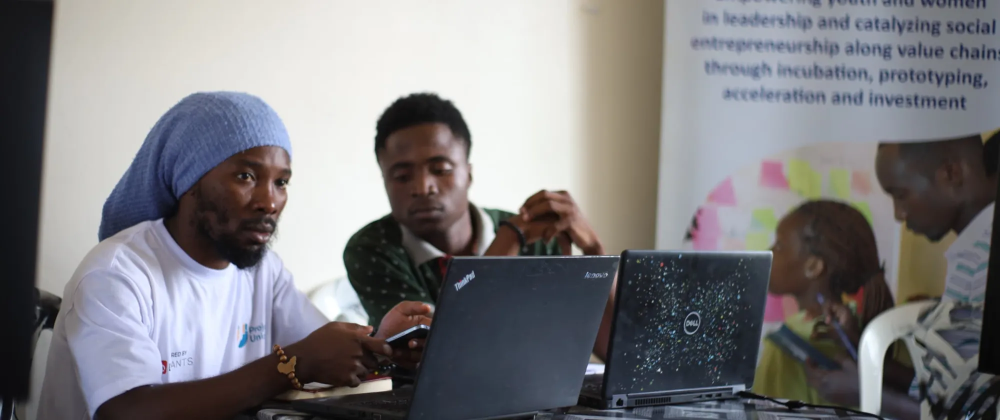 Two young men working on their laptops