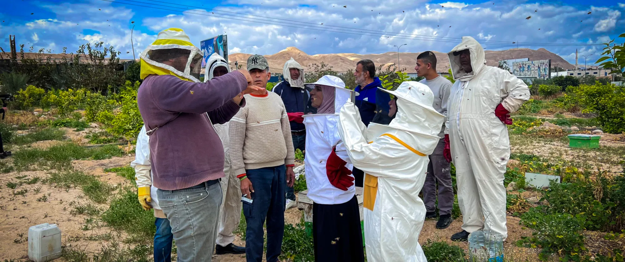 a group of people having a beekeeping training