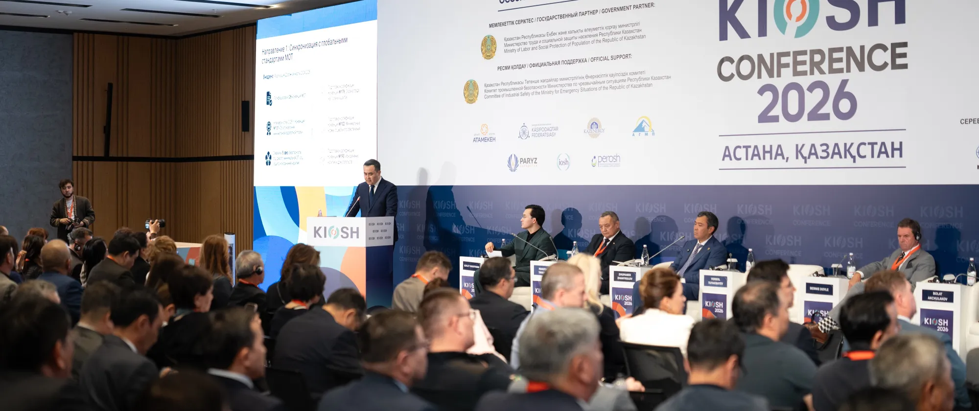 A person speaking at a podium in front of audience