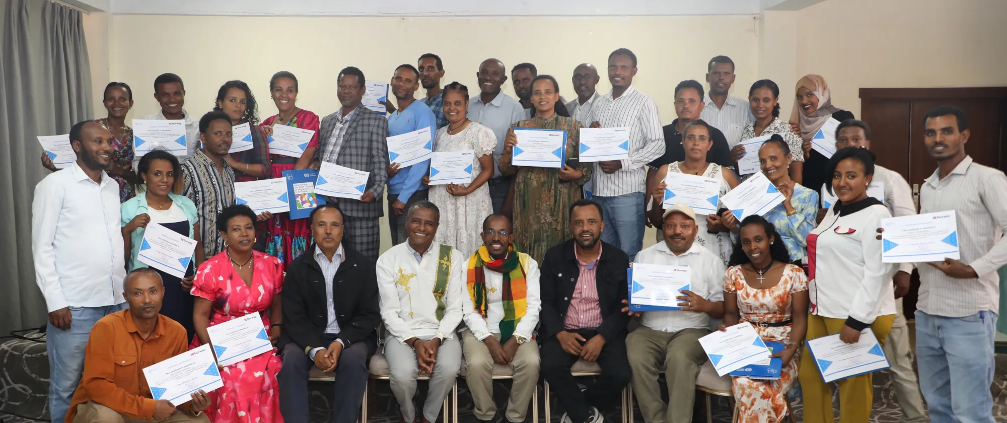 Group photo of trainees with their certificates