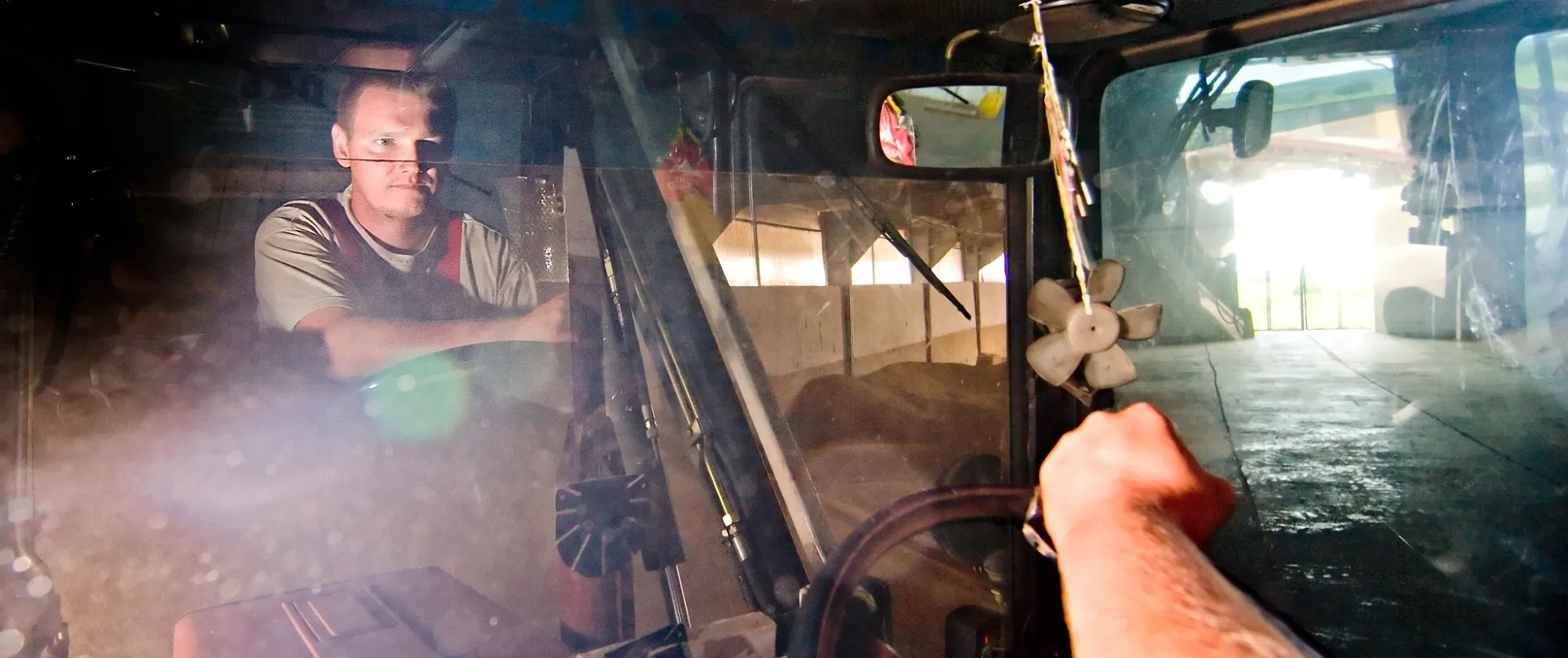 Man driving farm machinery.
