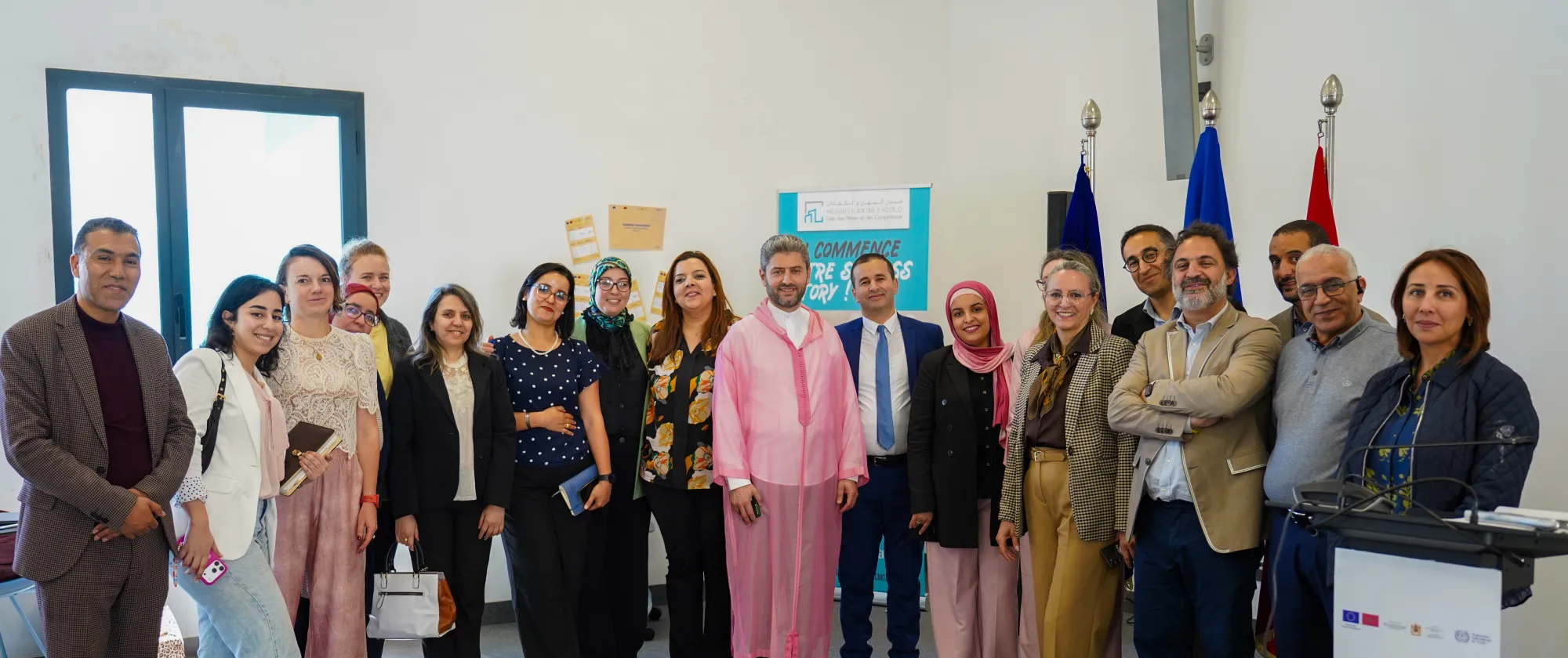 Groupe de participants posant pour une photo lors d’un atelier organisé dans une salle de conférence.