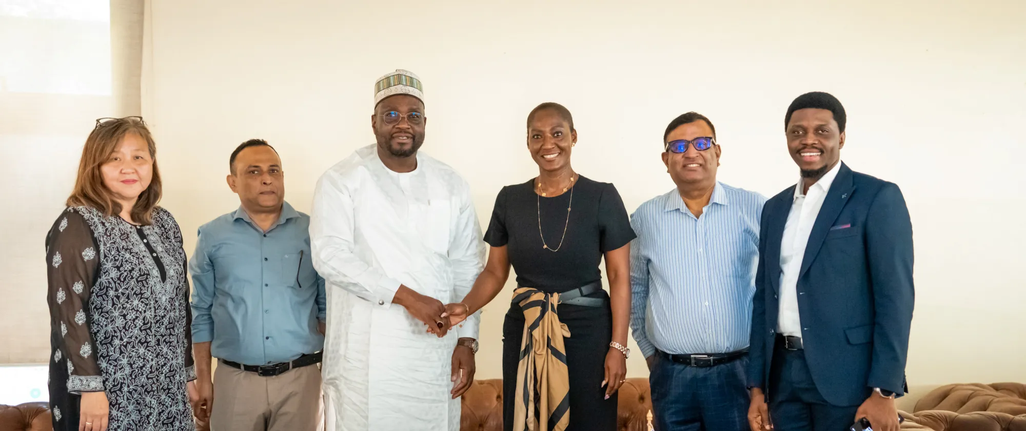 Representatives of the International Labour Organization and Nigeria’s Rural Access and Agricultural Marketing Project pose together after signing a partnership agreement in Abuja. ILO Country Director Dr Vanessa Phala and RAAMP National Coordinator Engr. Aminu Bodinga Mohammed shake hands at the centre of the group.