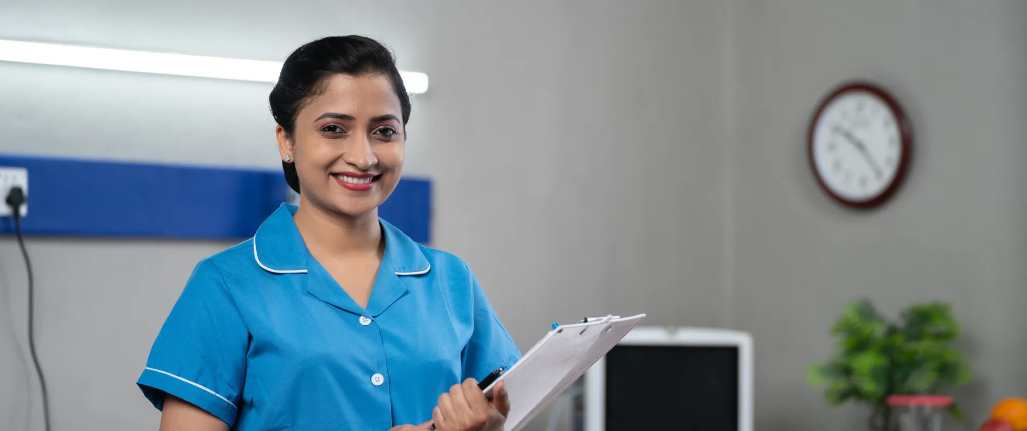 A lady in blue uniform holding a file.