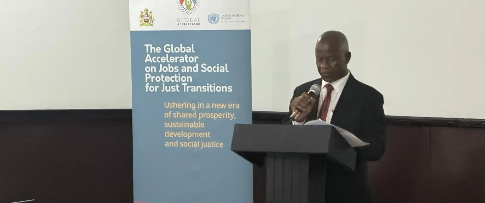 Mr. George Masinga, Director of Administration at MoLSI speaks at the event.