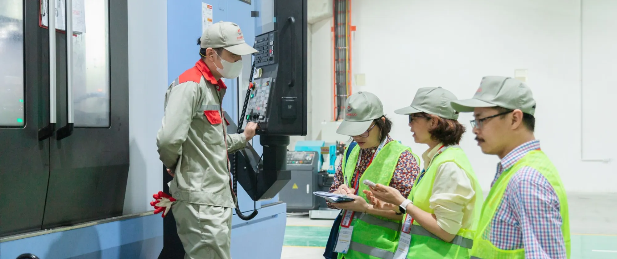 Consultants exchange on continuous improvement with workers during field activities of the Training of Trainers programme