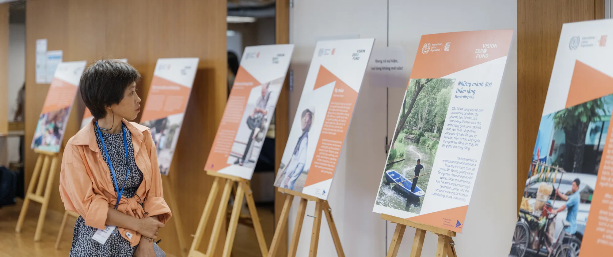 Participants view exhibition of "Mosaics of Work" photo competition
