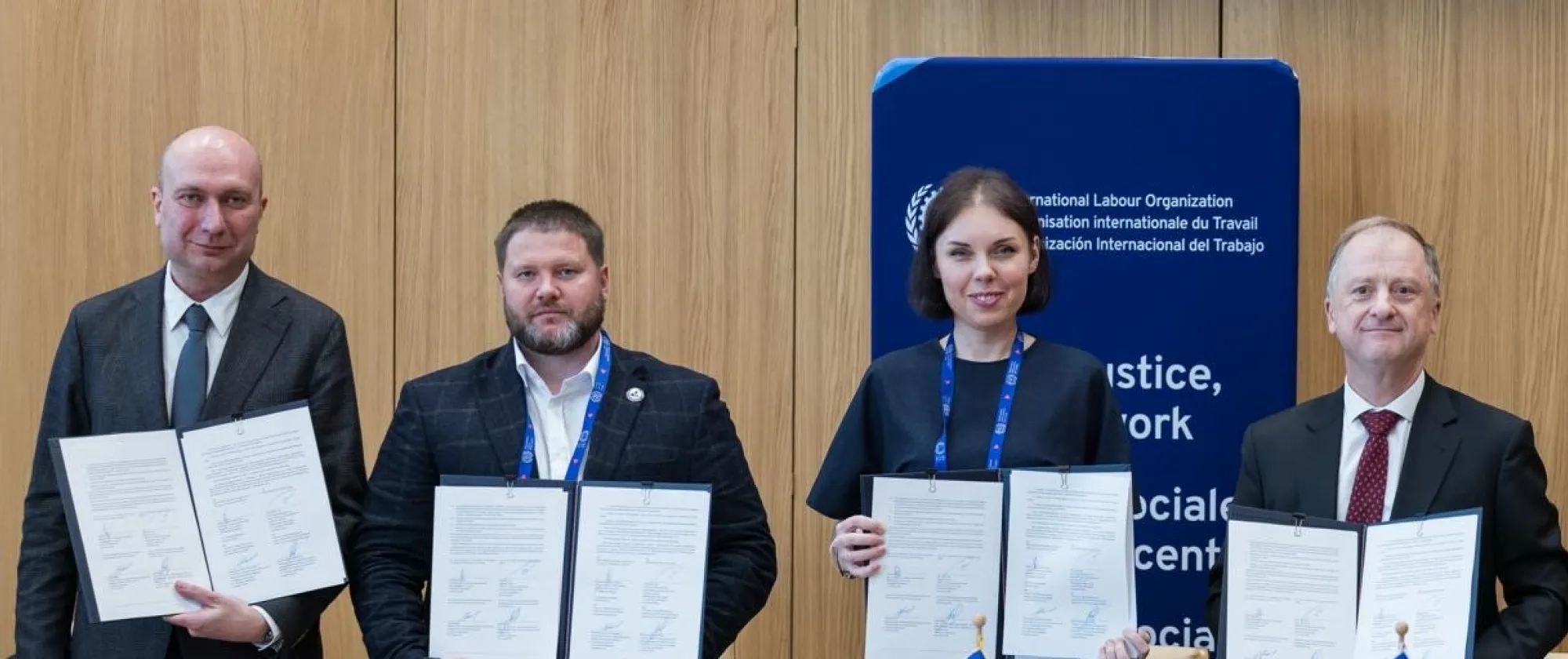 Signatories holding signed documents
