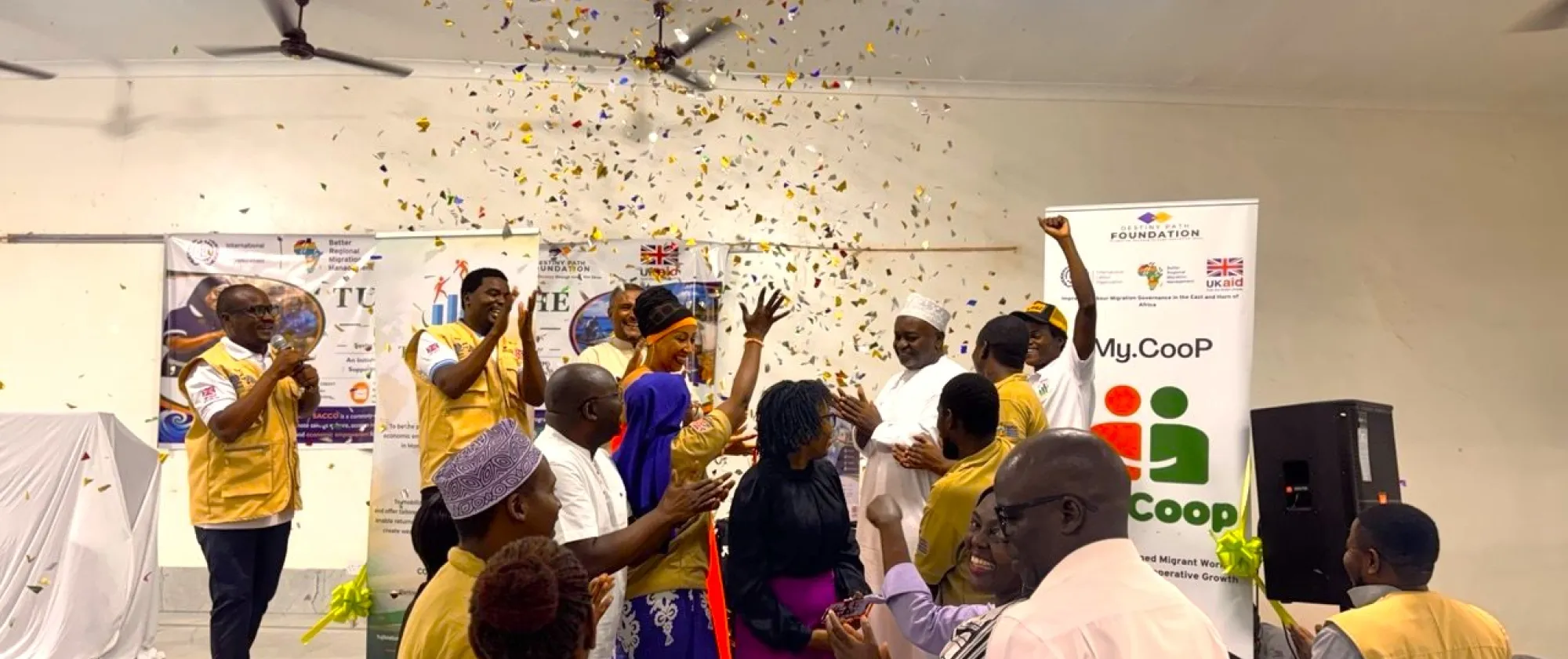 Participants celebrate the launch of a SACCO with confetti, clapping and cheering during an event in Mombasa