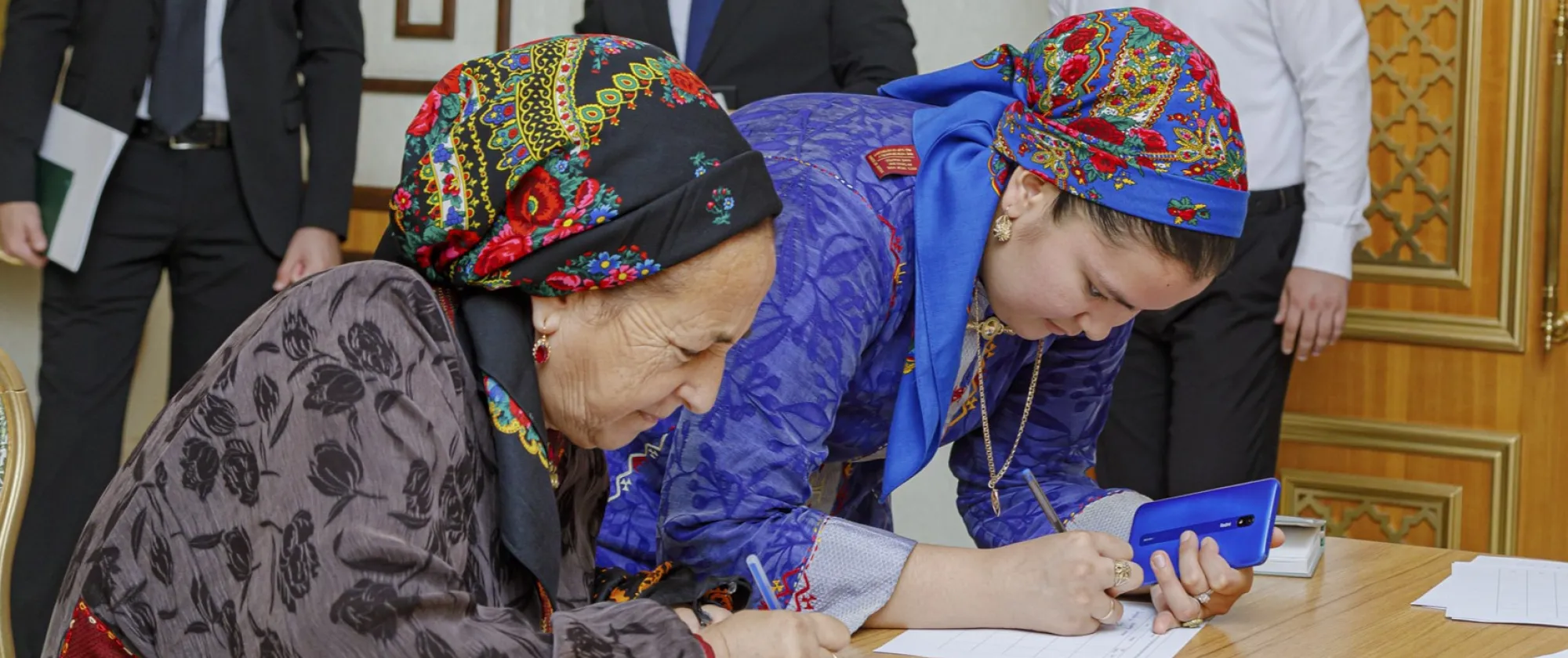 Two women writing on paper