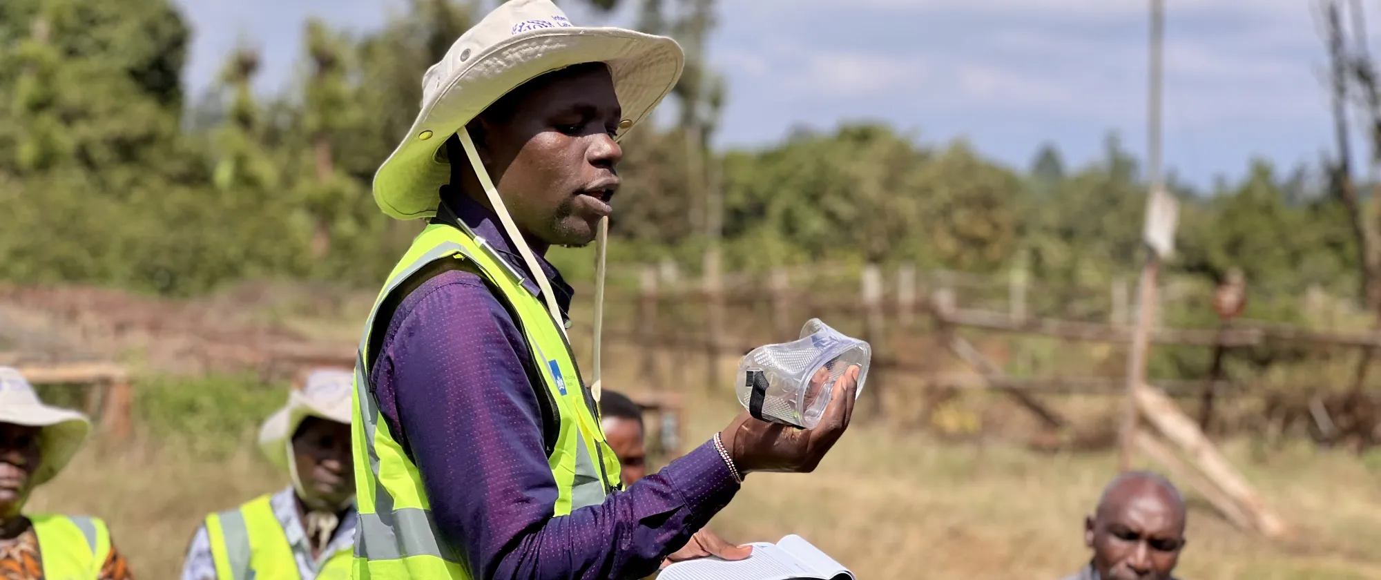 An OSH trainer demonstrates sample PPE during WIND advocacy.