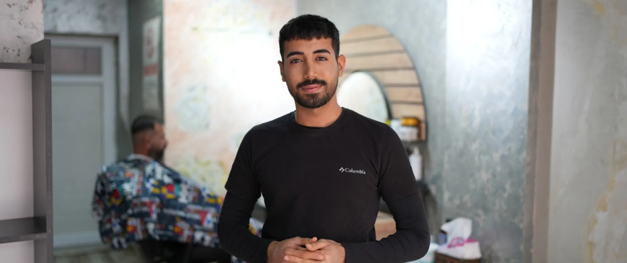 22-year-old man called Halid Fahil in his hair cut shop
