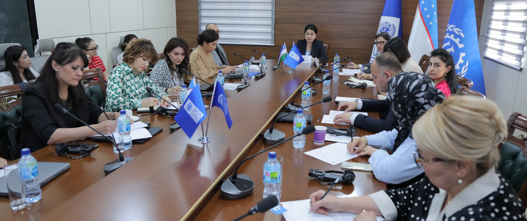 Participants seated around a long conference table