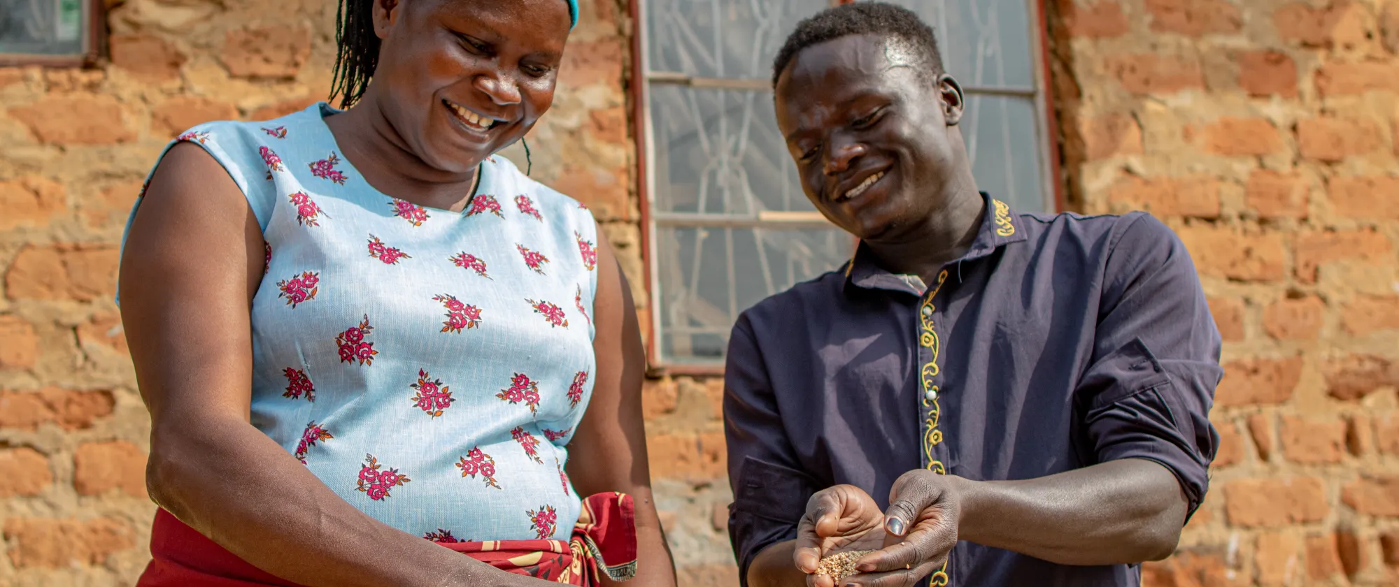 man and woman farmer holding produce in their hands