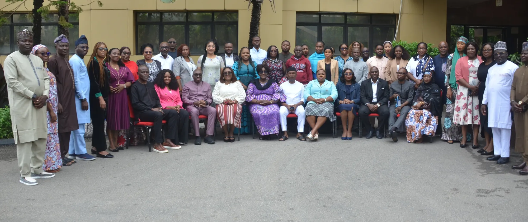 Large group of participants, facilitators and officials posing for a photograph outside the training venue in Abuja following a TRANSFORM capacity-building session.