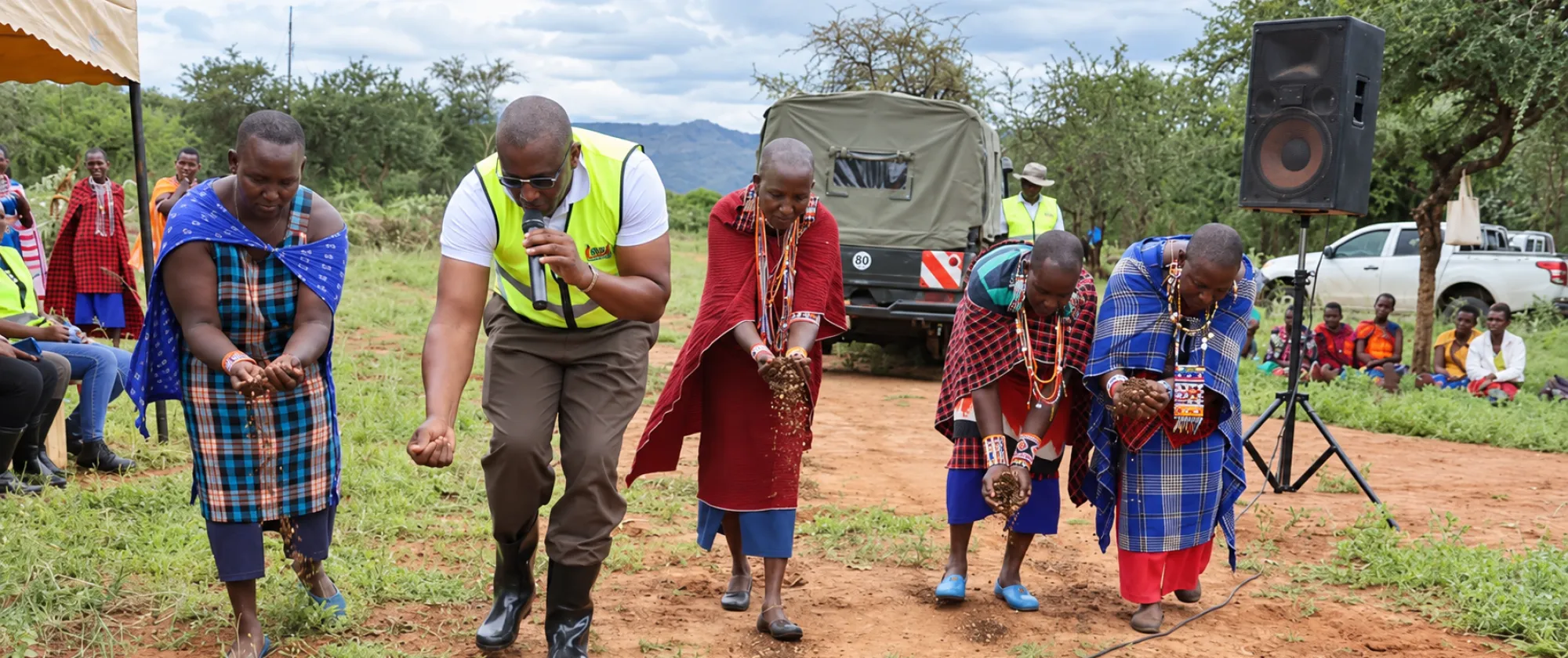 Erick Ahenda demonstrating pasture reseeding techniques to a women group at Mile Tisa, Matapato south ward, Kajiado central Subcounty