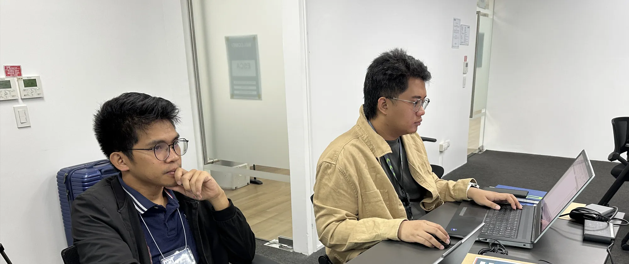 Two male participants using the Building Information Modeling on their computers.