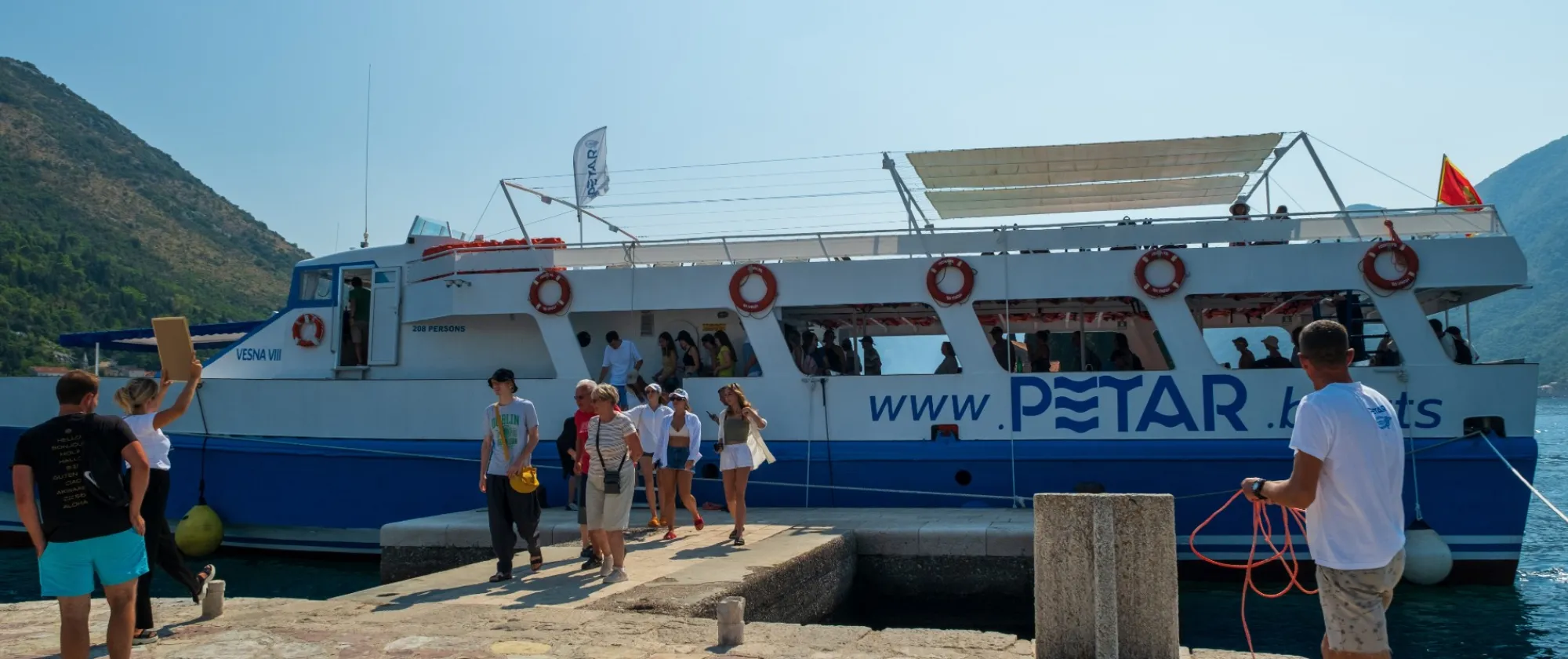 Tourists disembarking a boat in Montenegro, 2025.