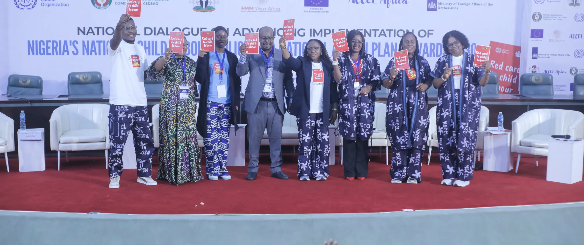Nigeria panelist pose for a photo with panels against child labour