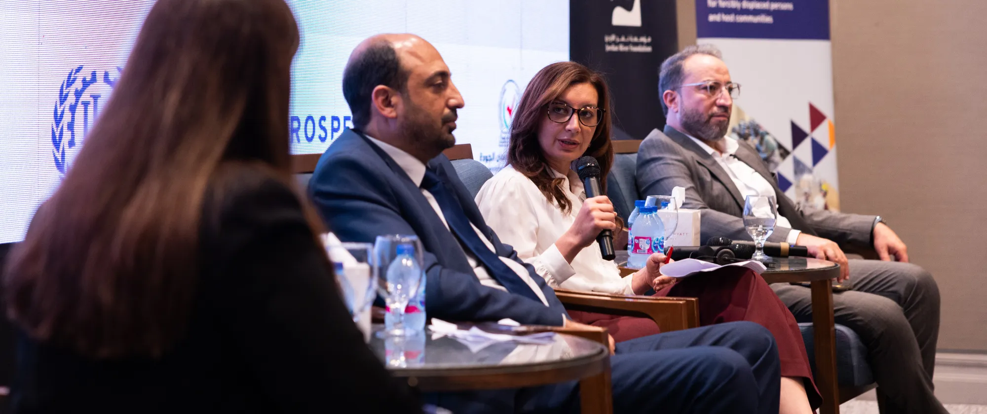panel members at jordan event speaking from the podium