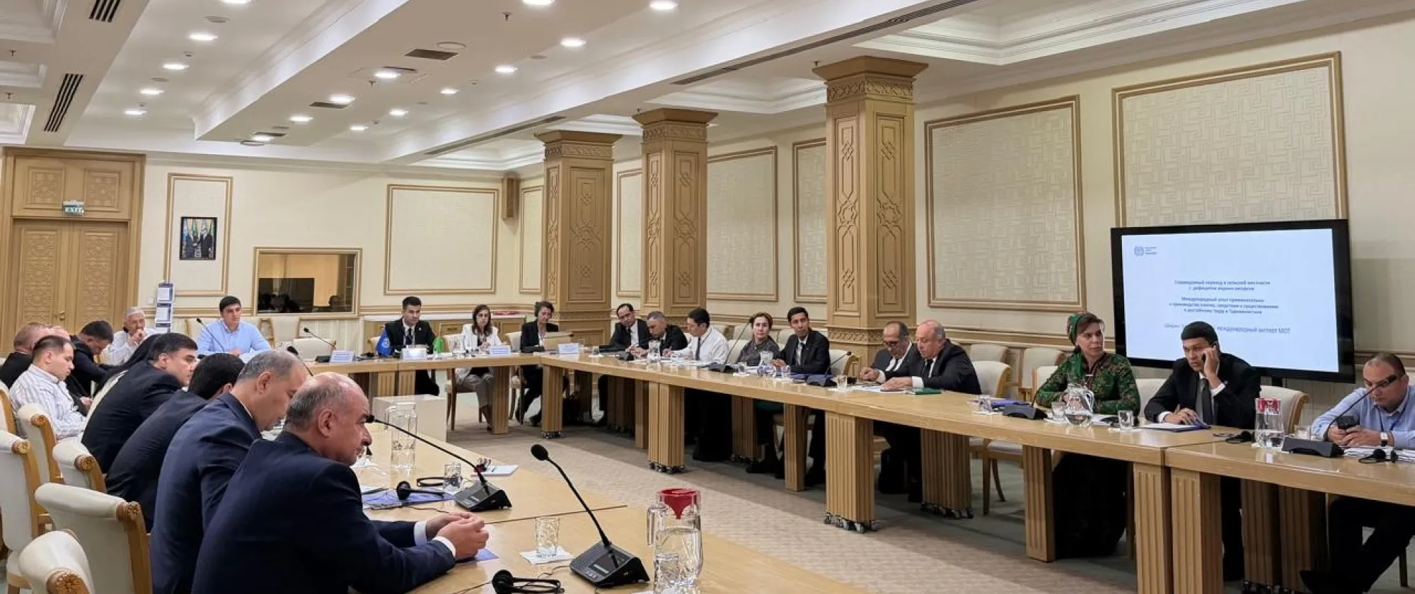 People sitting around U-shaped conference table
