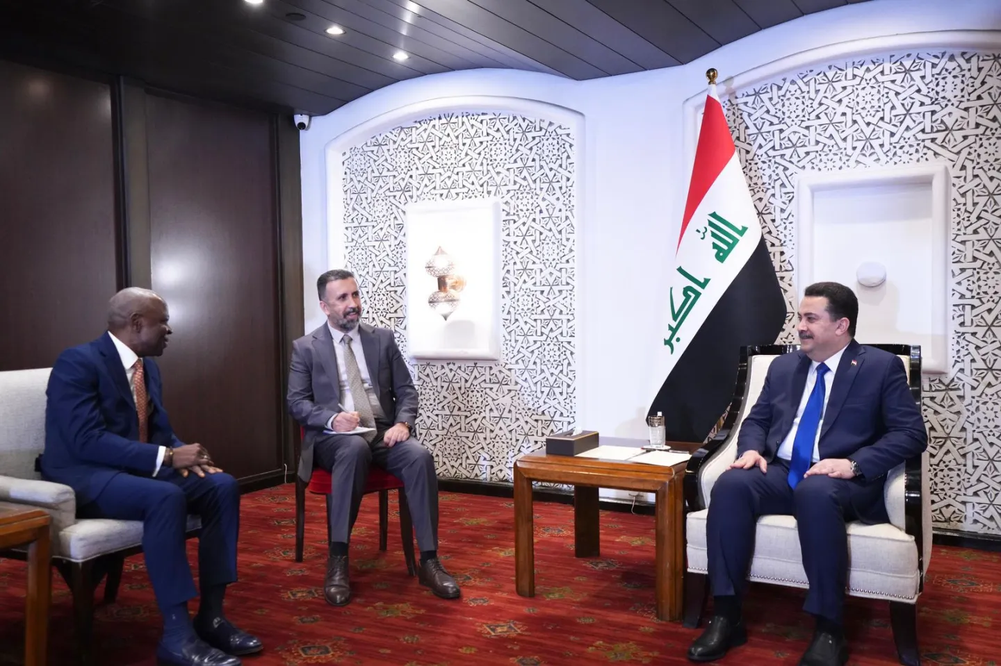 three men in a meeting