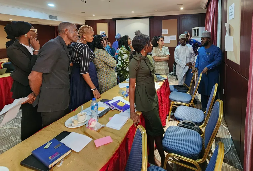 Participants in a group discussion deliberate their findings