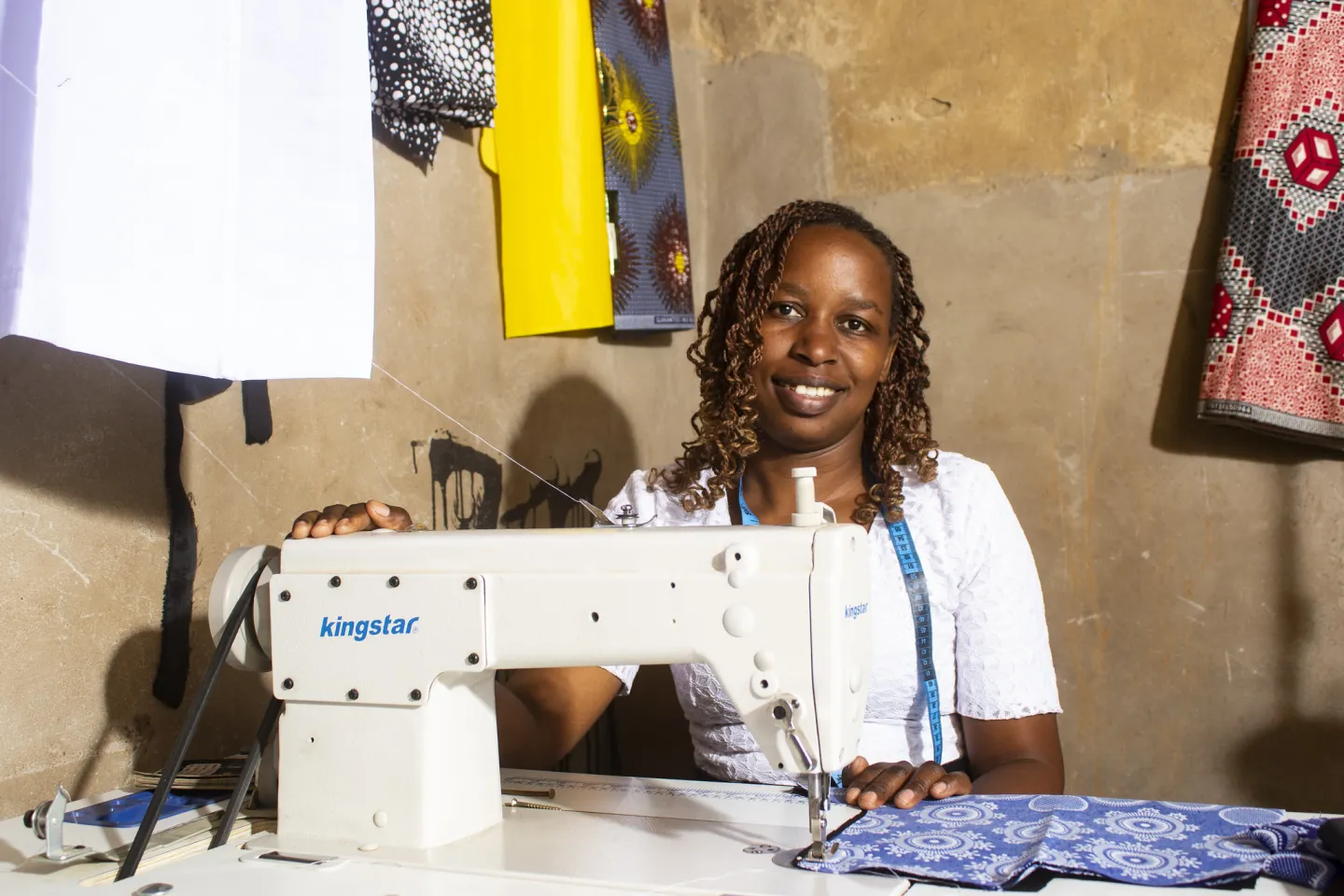 Seamstress in Zimbabwe behind her sewing machine