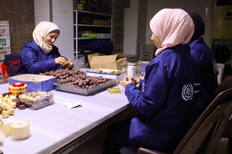 Two women working at the chocolate factory 