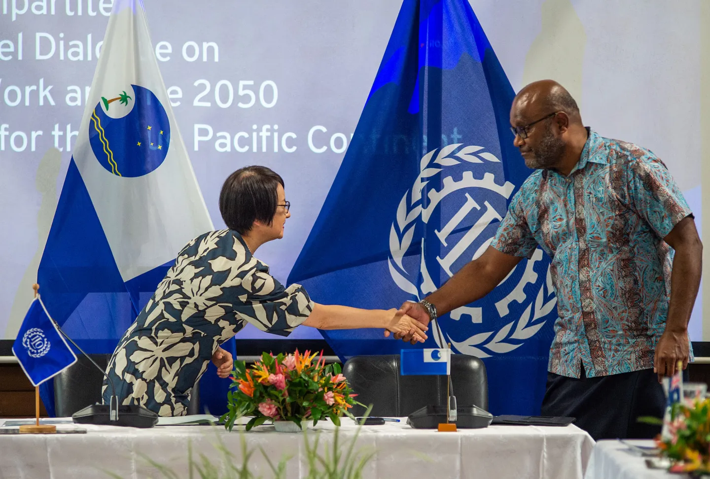 Chihoko Asada-Miyakawa, ILO Assistant Director-General and Regional Director for Asia and the Pacific and Esala Nayasi, Acting Secretary General of the Pacific Islands Forum Secretariat celebrate the signing
