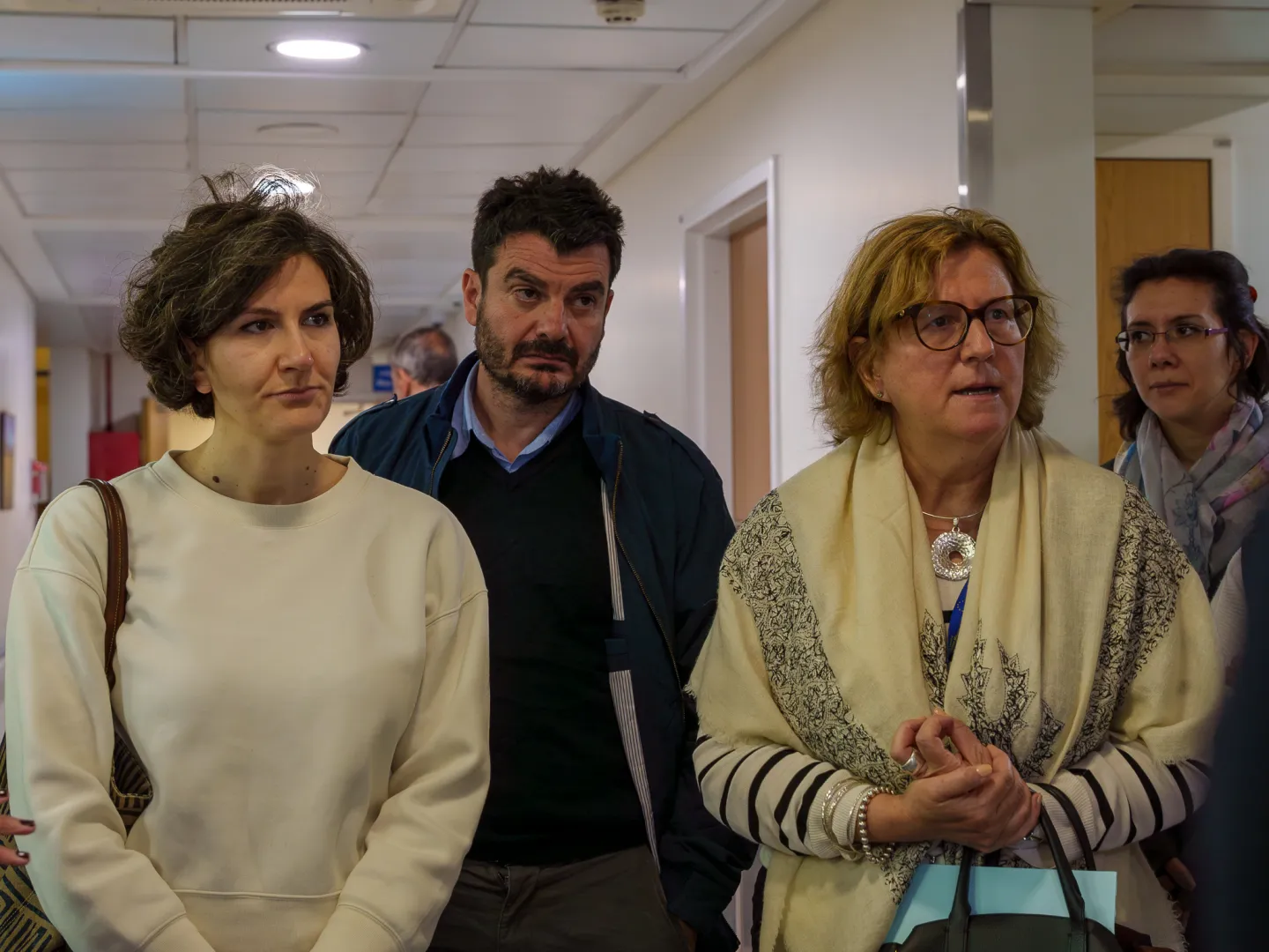 2 women and a men standing in a factory