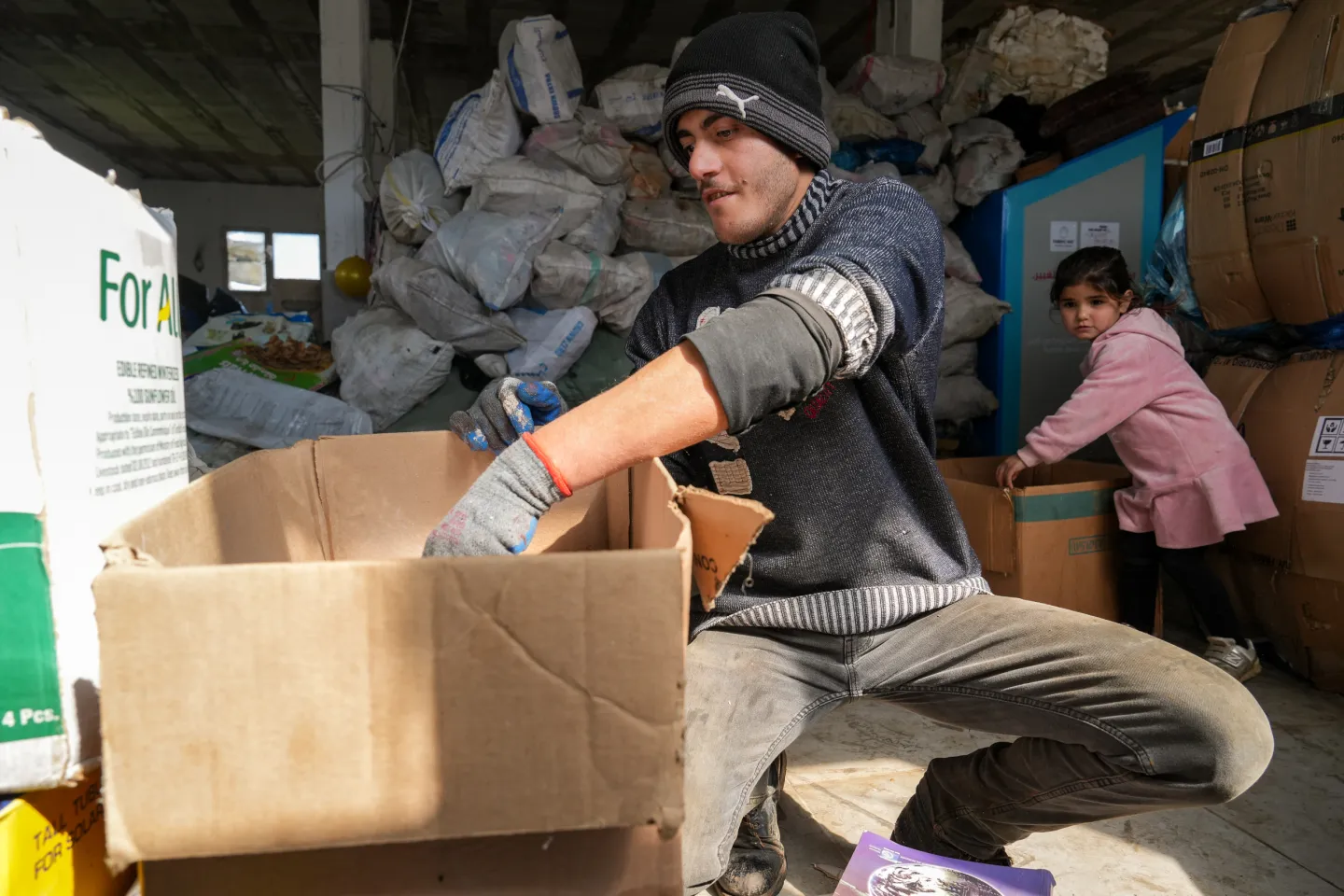 man sorting paper at garbage recycling unit in lebanon