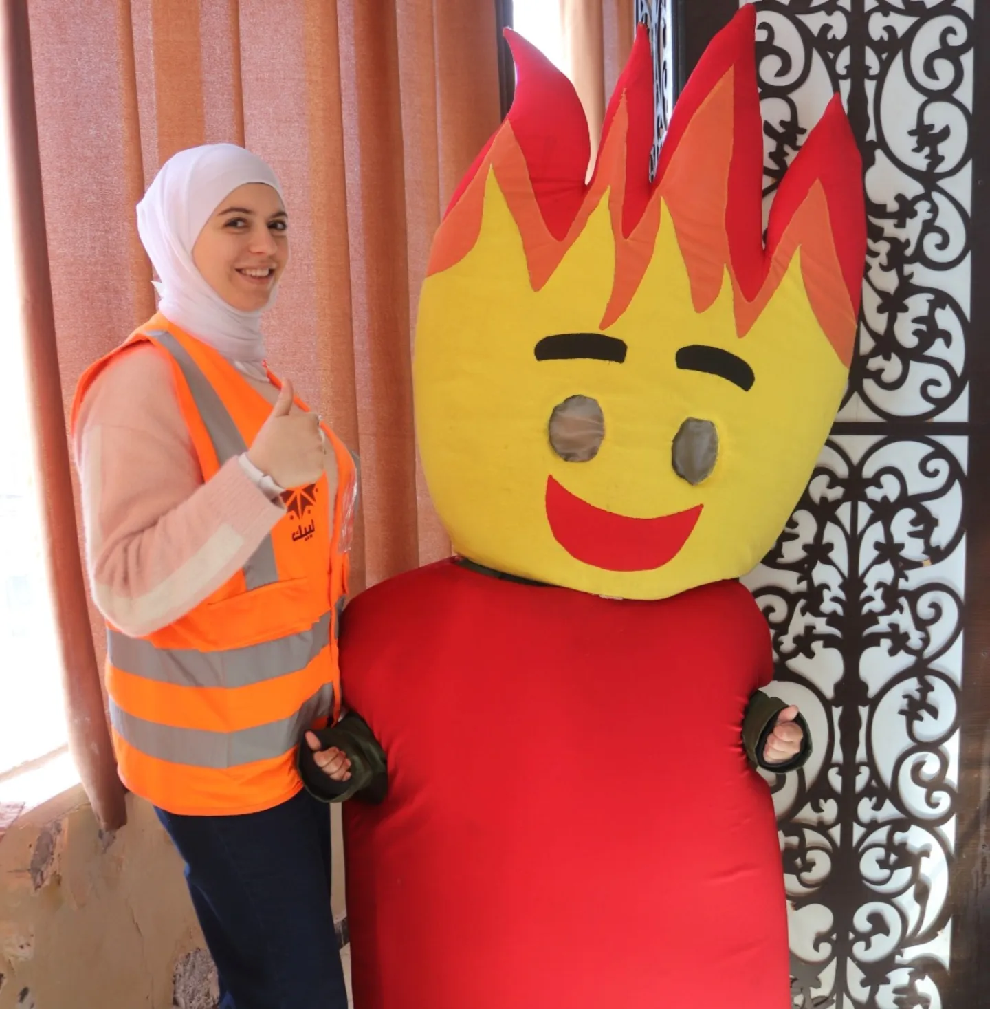 a lady standing next to a mascot 