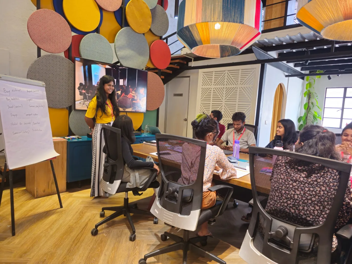 Training session in a vibrant room sees participants seated around a table