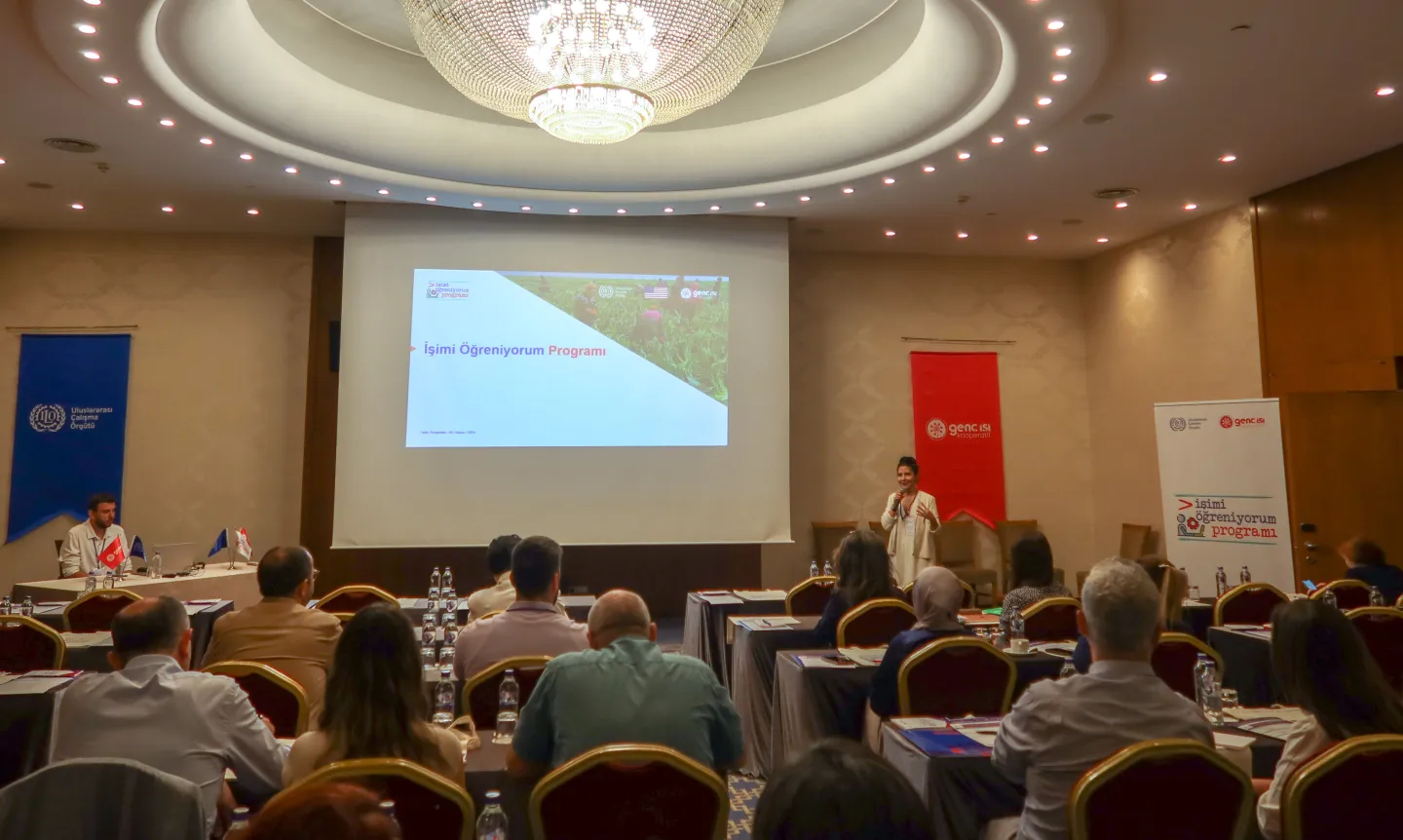 A woman presenting at a meeting hall, in Izmir, Turkiye