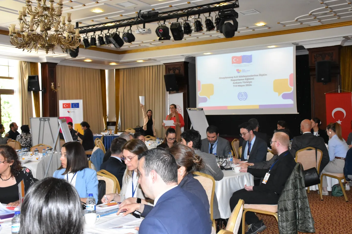 Presenter in front of a screen at a meeting hall in Turkiye