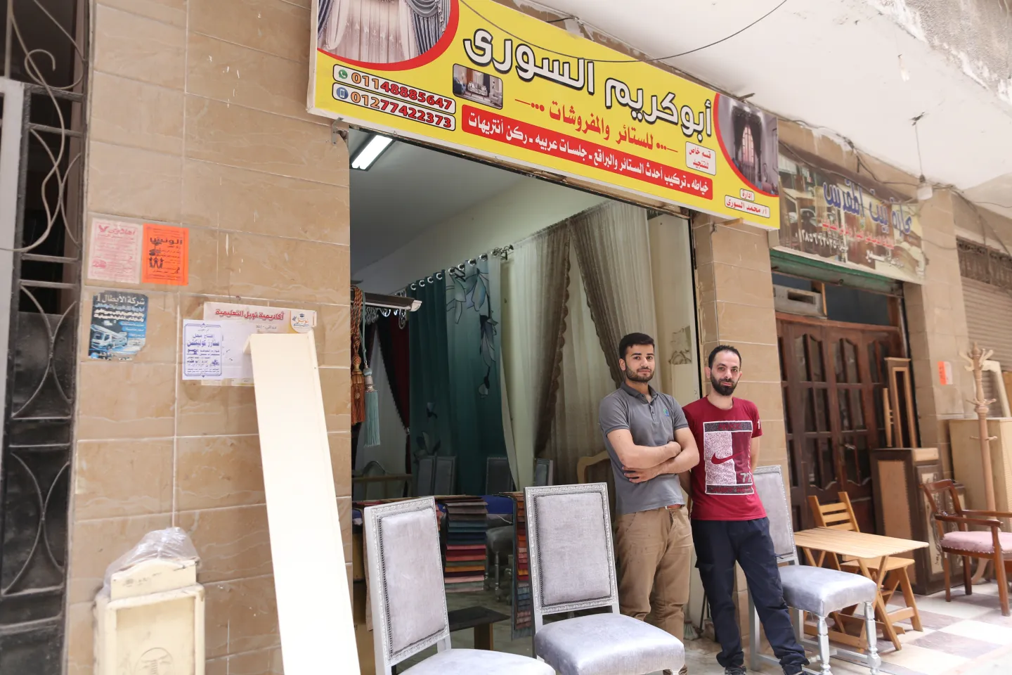 men standing outside the shop