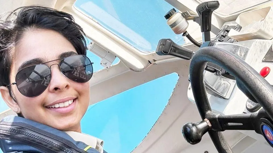 Nayomi Amarasinghe at helm of a tender boat