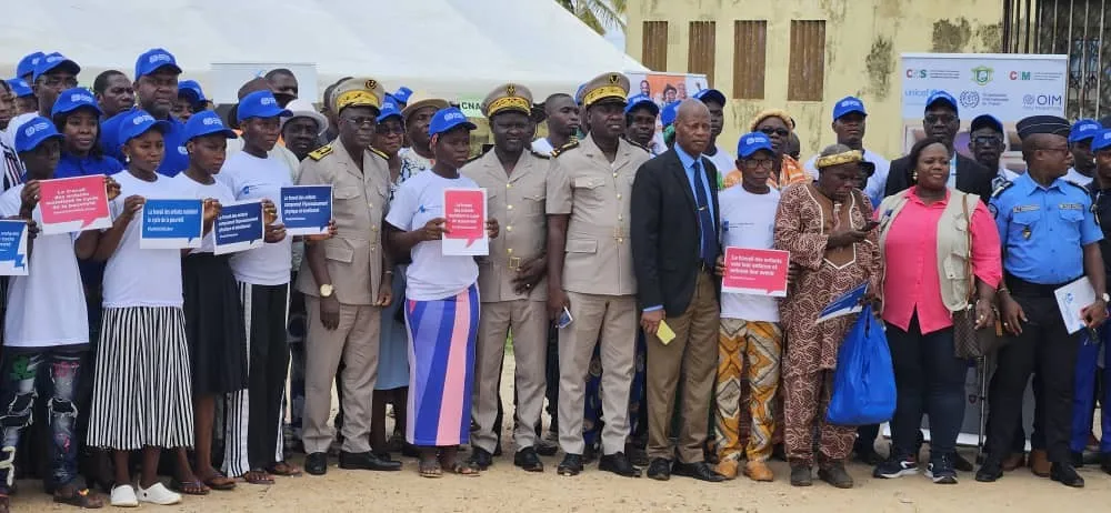 Participants pose with messages against child labour