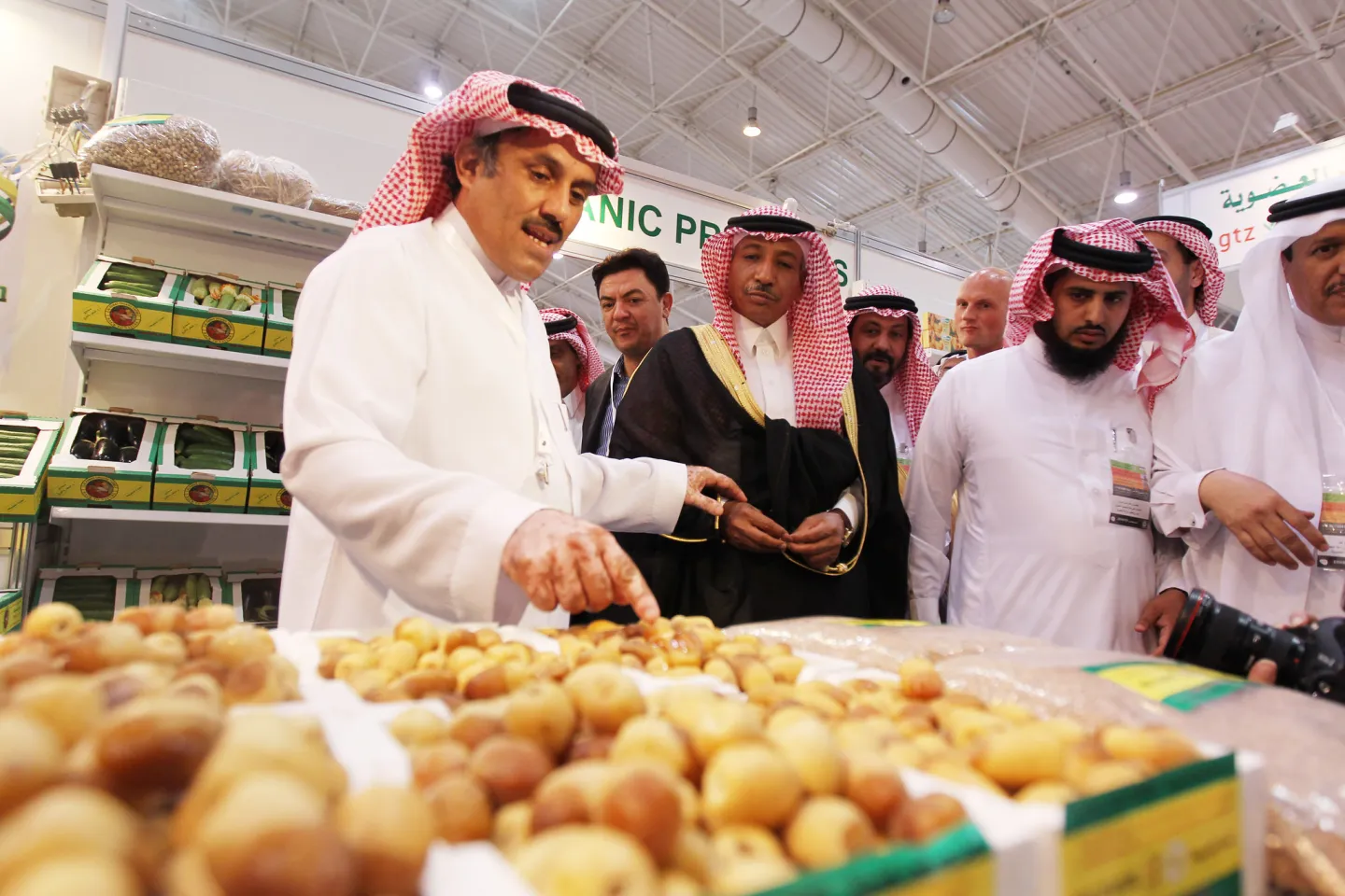 A local produce seller displays his dates to clients at an exhibition.