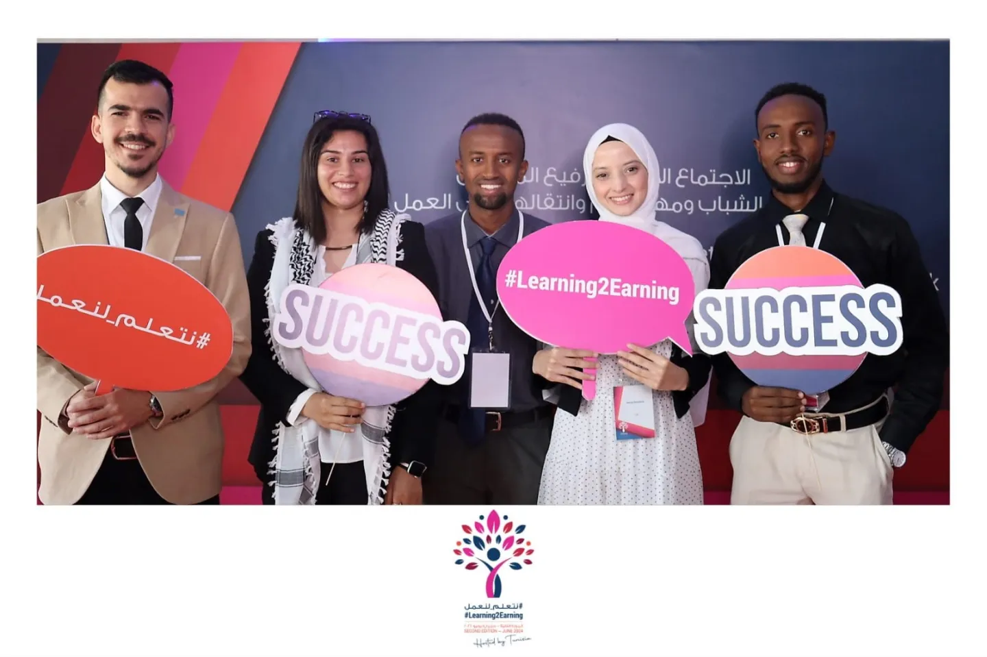 Five young women and men hold signage that reads, Success