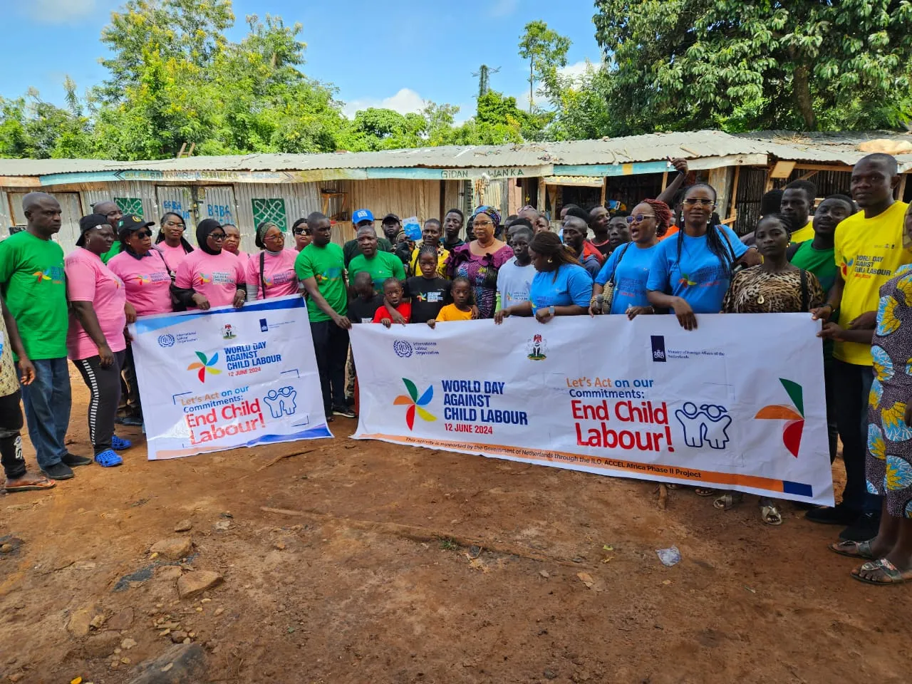 Participants hold two banners of the world day against child labour