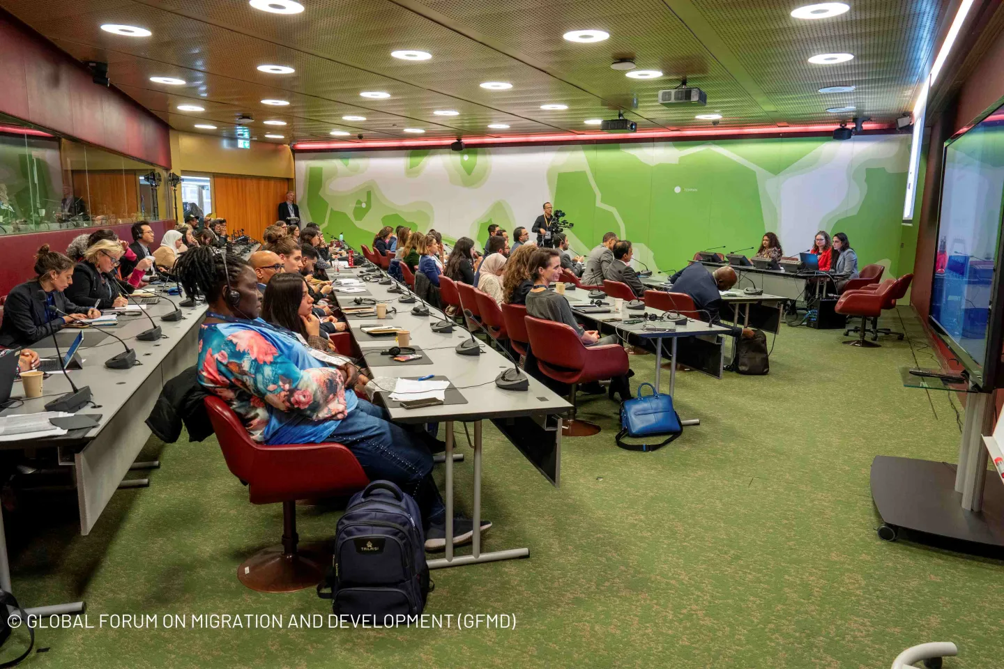 Participants to a Forum, listening with headsets on