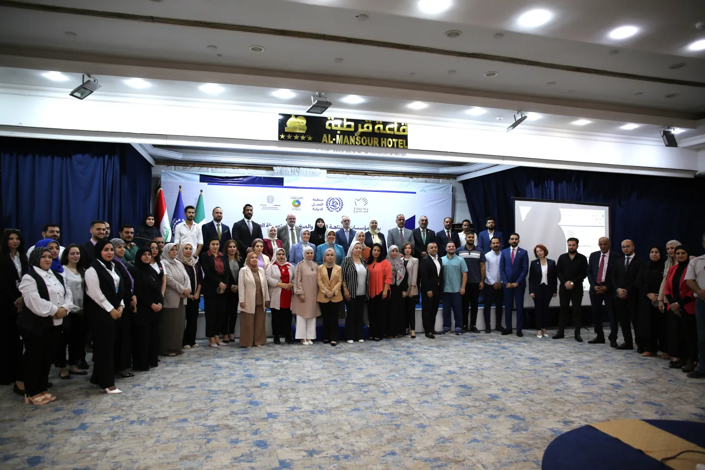 A group of participants lined up to pose at an event in Baghdad, Iraq