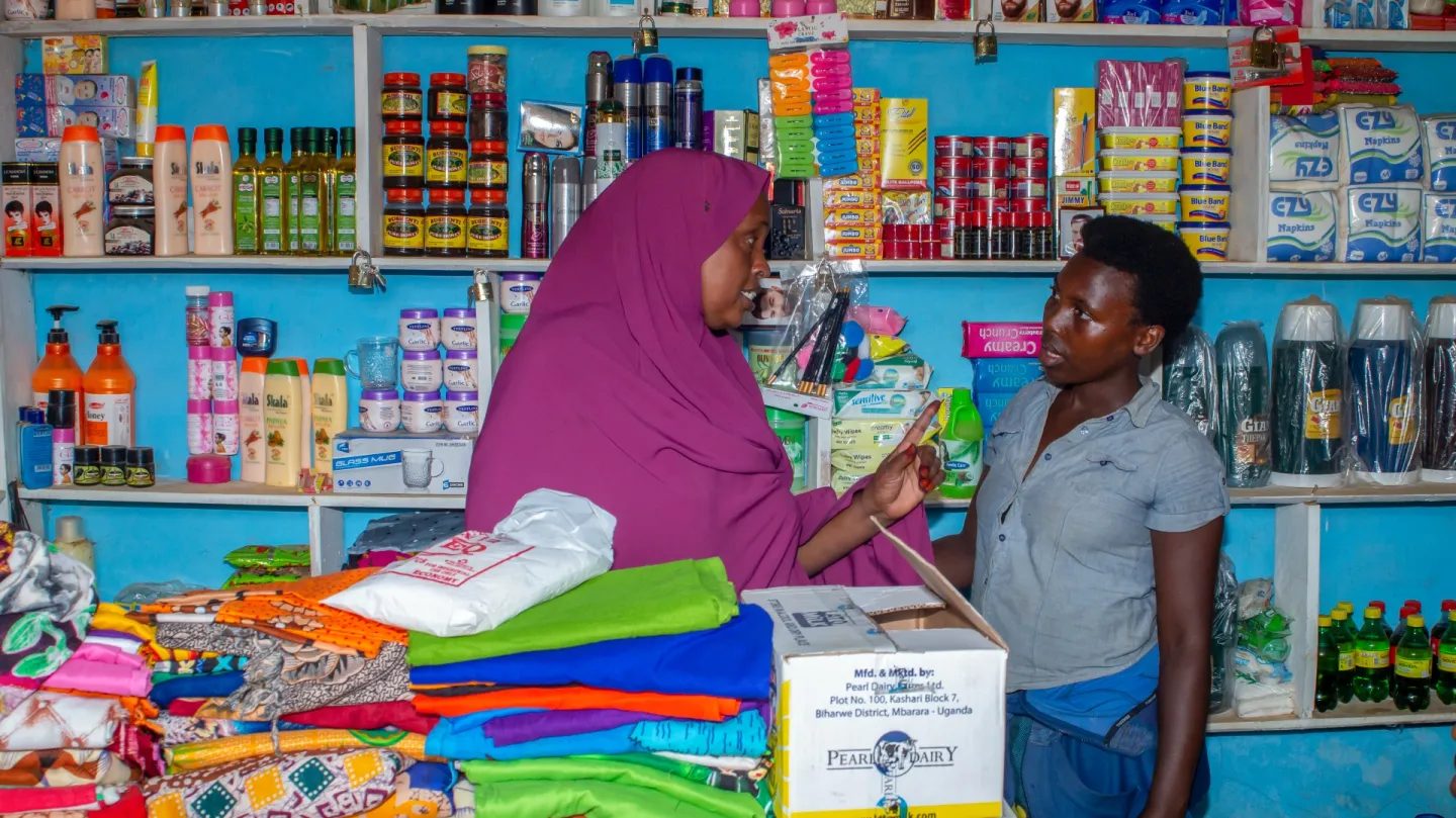 woman speaking to shopkeeper