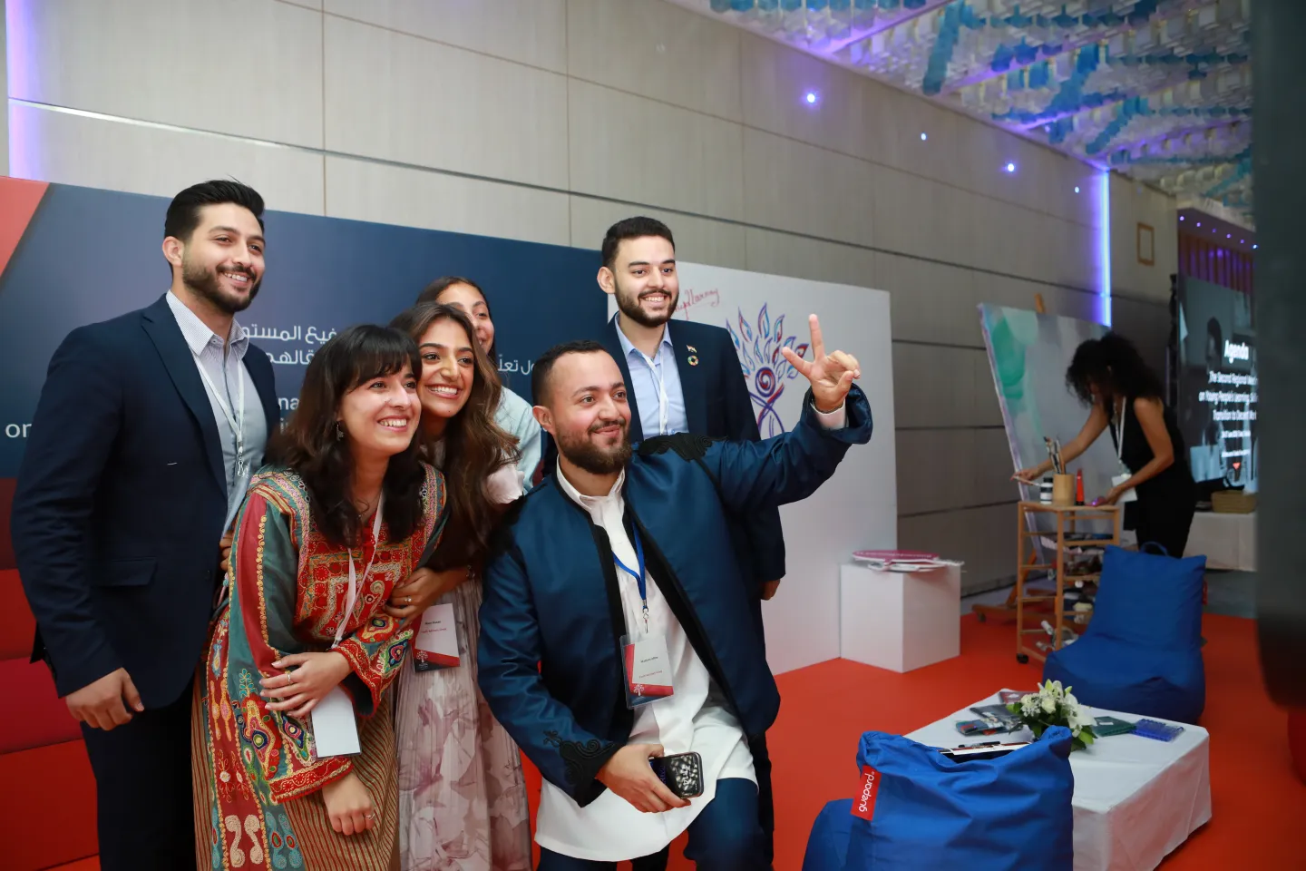 Youth representatives posing for photo, while one strikes a peace sign, in Tunis, Tunisia